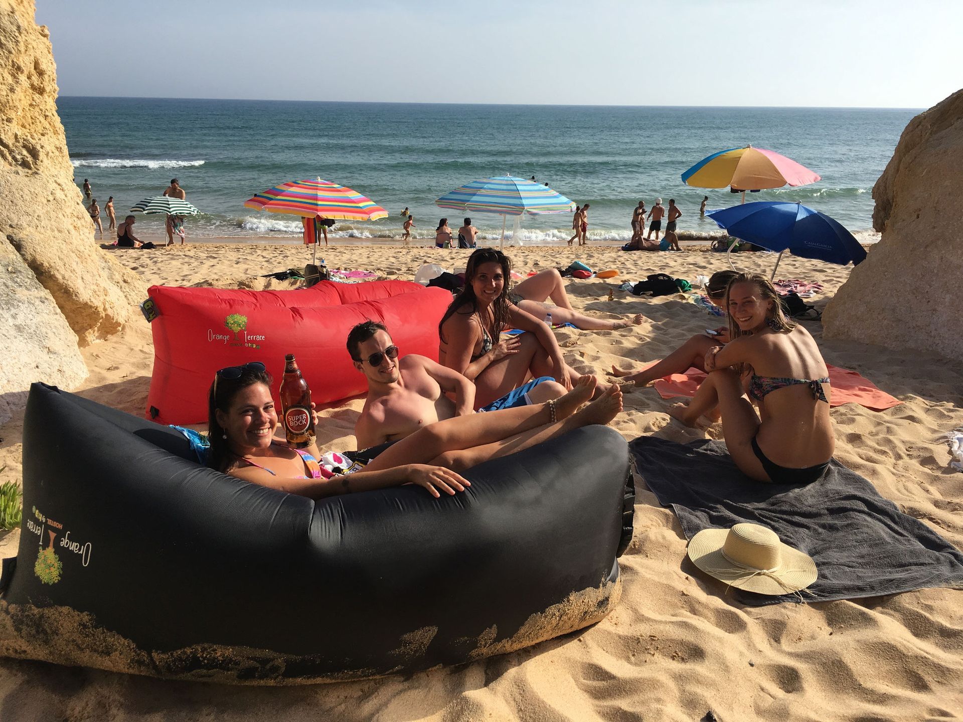a group of people are sitting on a beach .