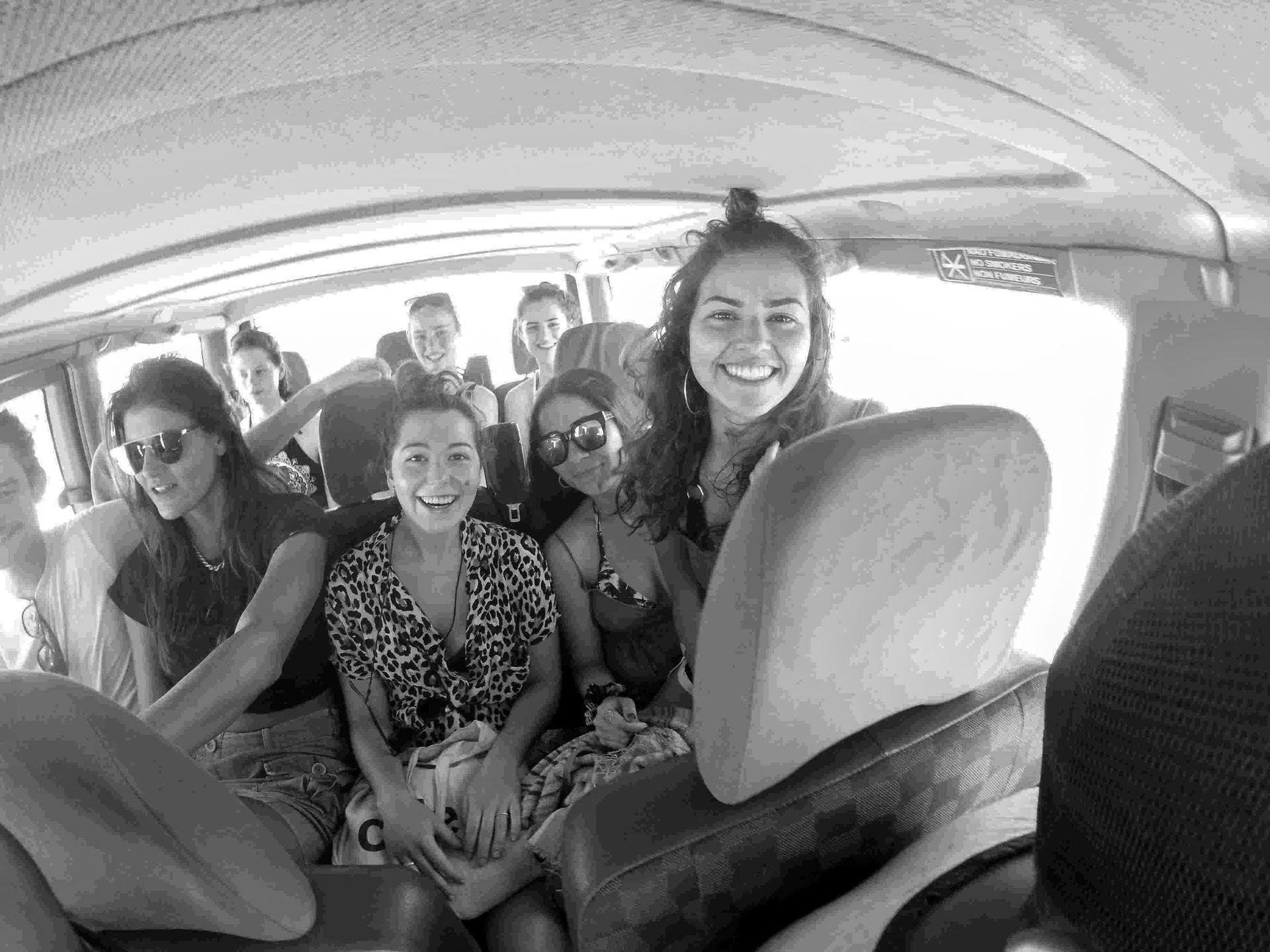 a group of people are sitting in the back seat of a van .