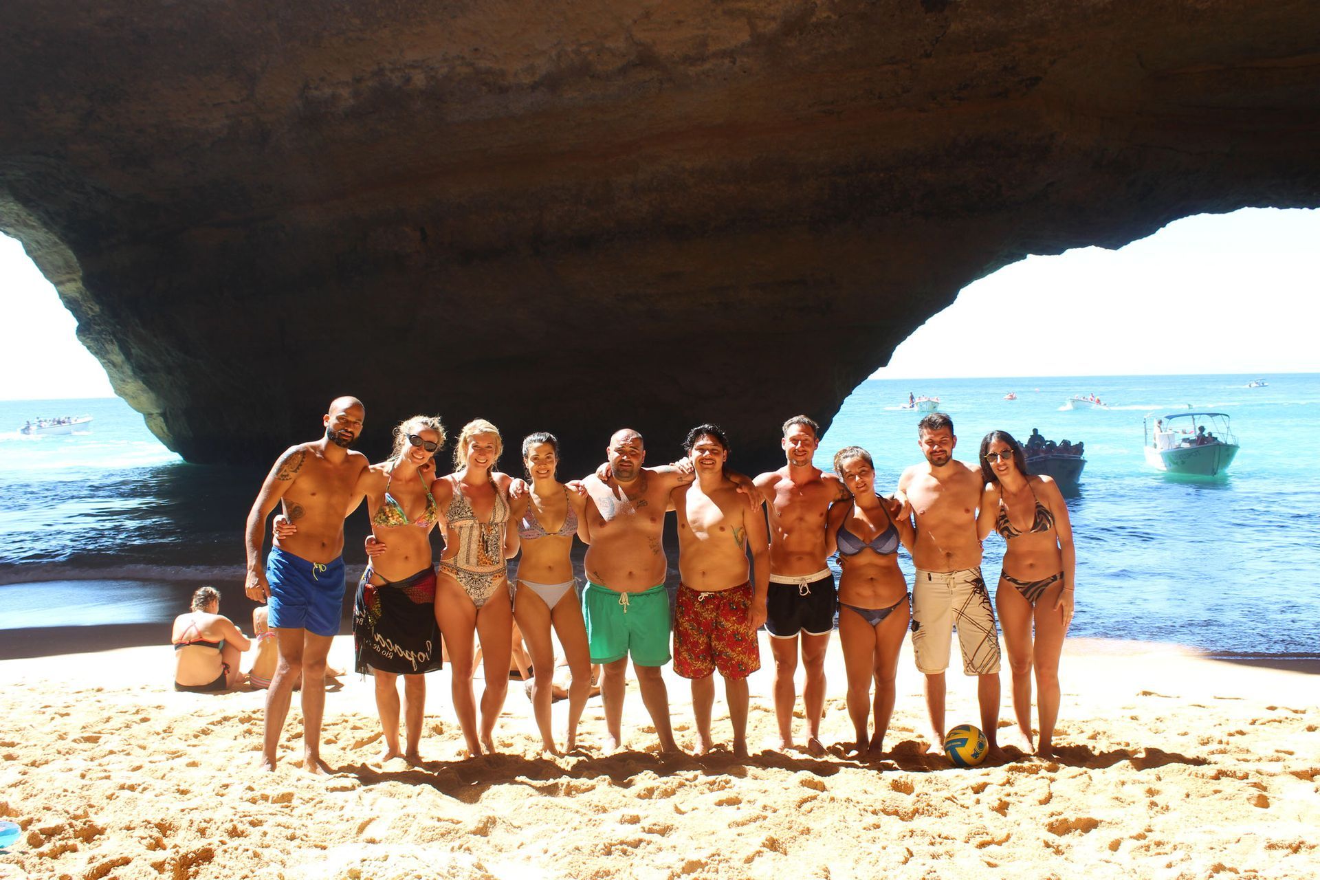 a group of people posing for a picture on a beach, Albufeira Portugal