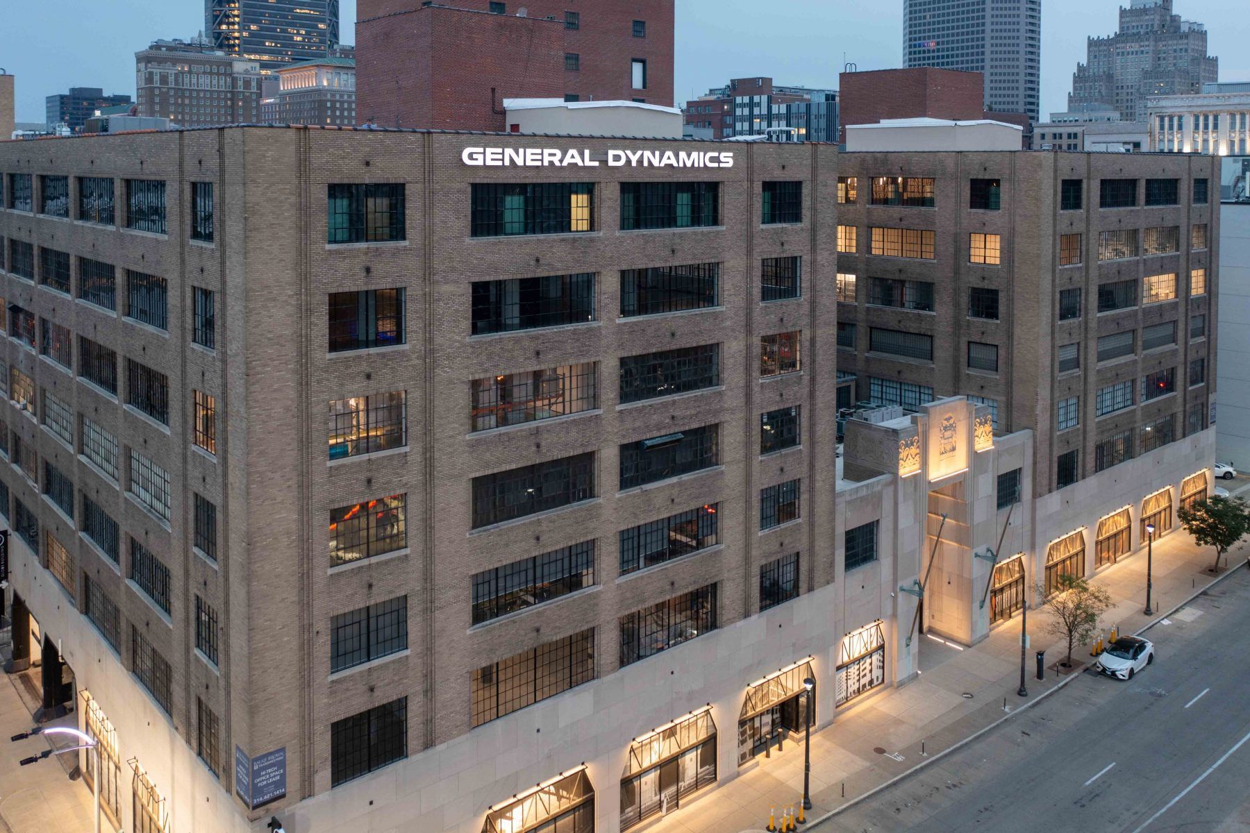 Exterior drone shot of The Globe Building lit up at night
