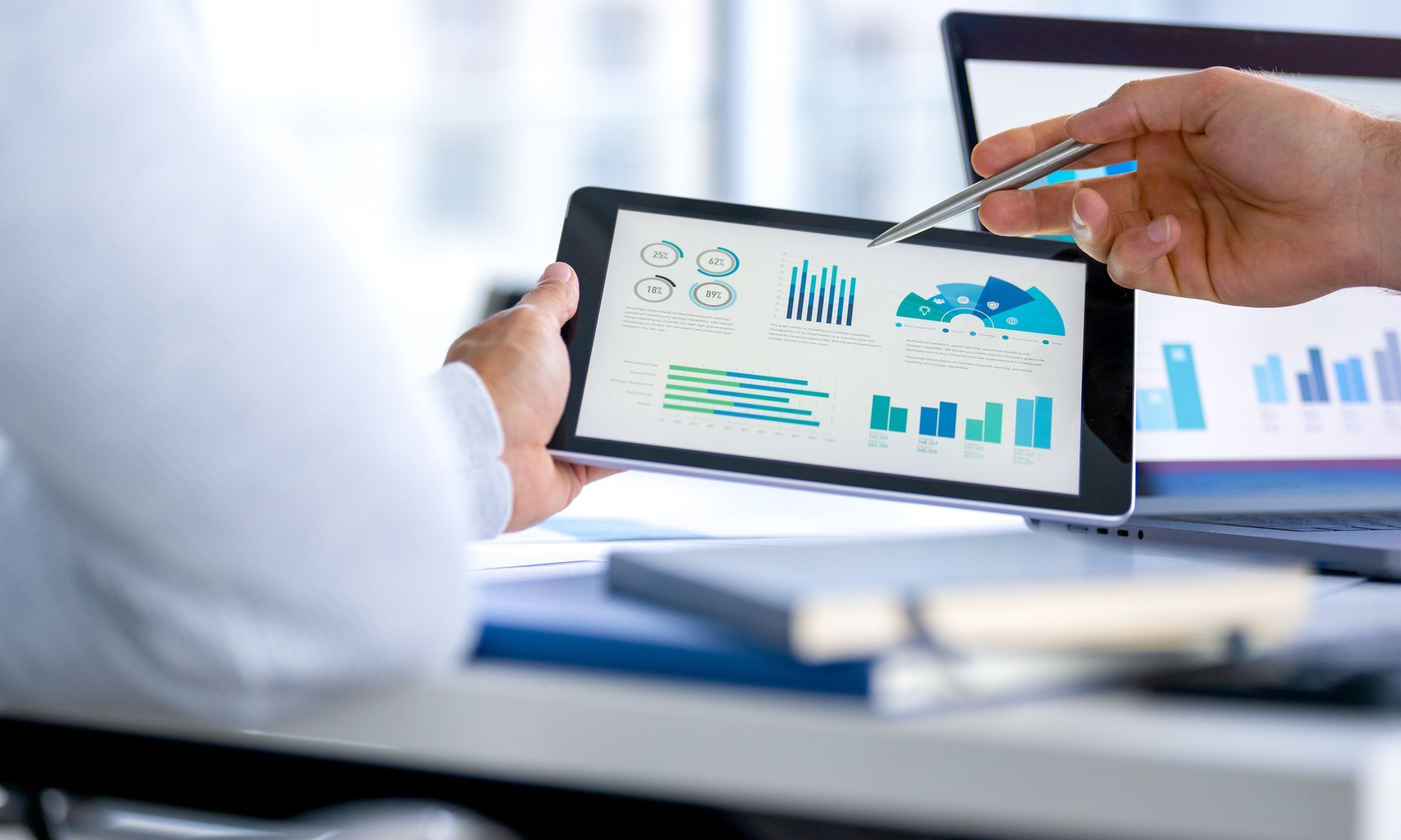 Business professionals analyze corporate data and charts for better management solutions. Business professionals analyze corporate data and charts for better management solutions.