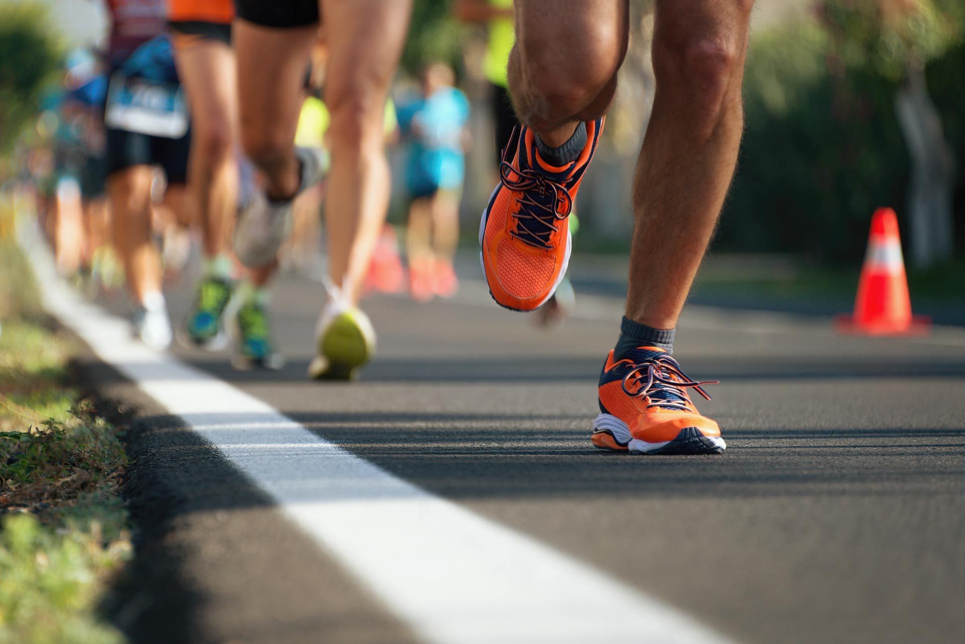 A group of people are running a marathon on a road.