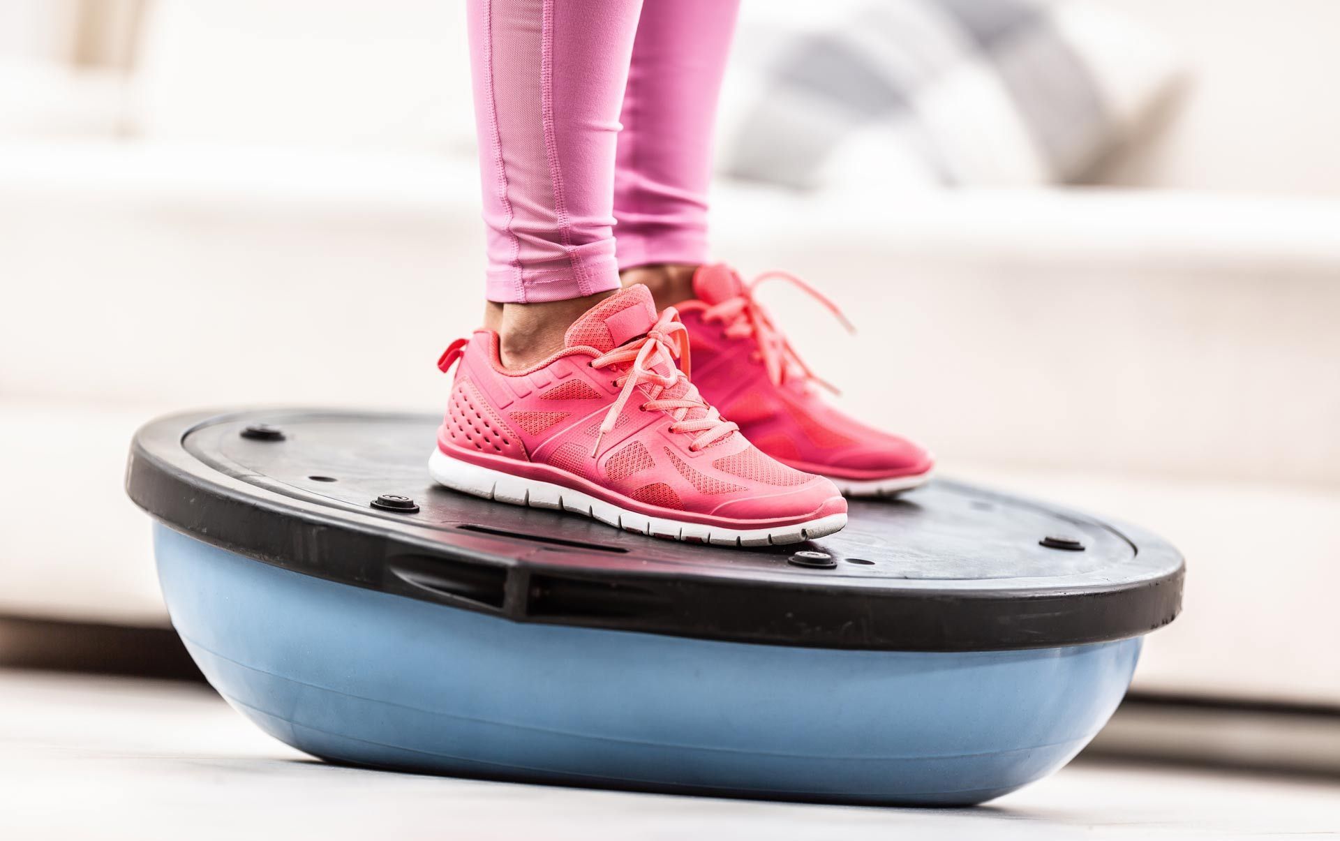 A person is standing on a balance ball.
