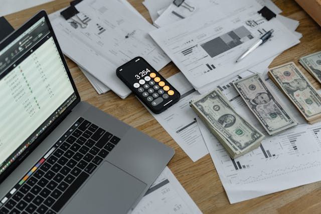 Cash and calculator on table