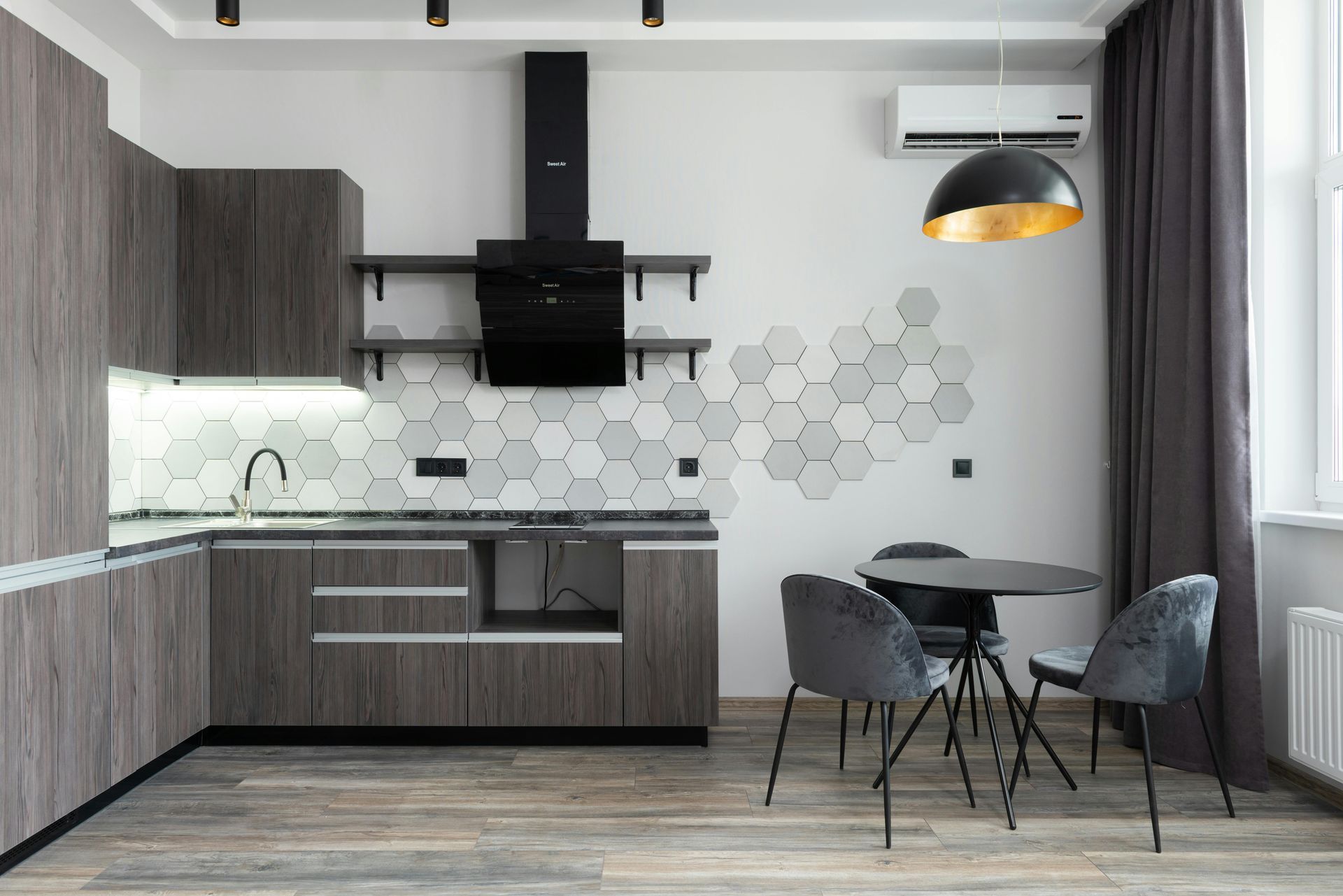 A simple and sleek modern kitchen with black, white, and grey features.