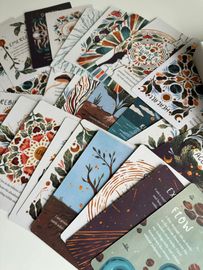 A collection of illustrated bookmarks featuring colorful patterns, floral designs, and landscapes arranged in a fan shape.