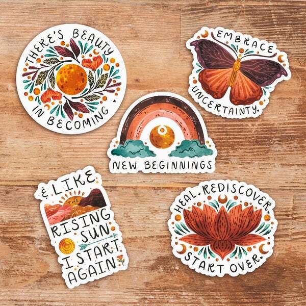 a bunch of stickers are sitting on a wooden table .