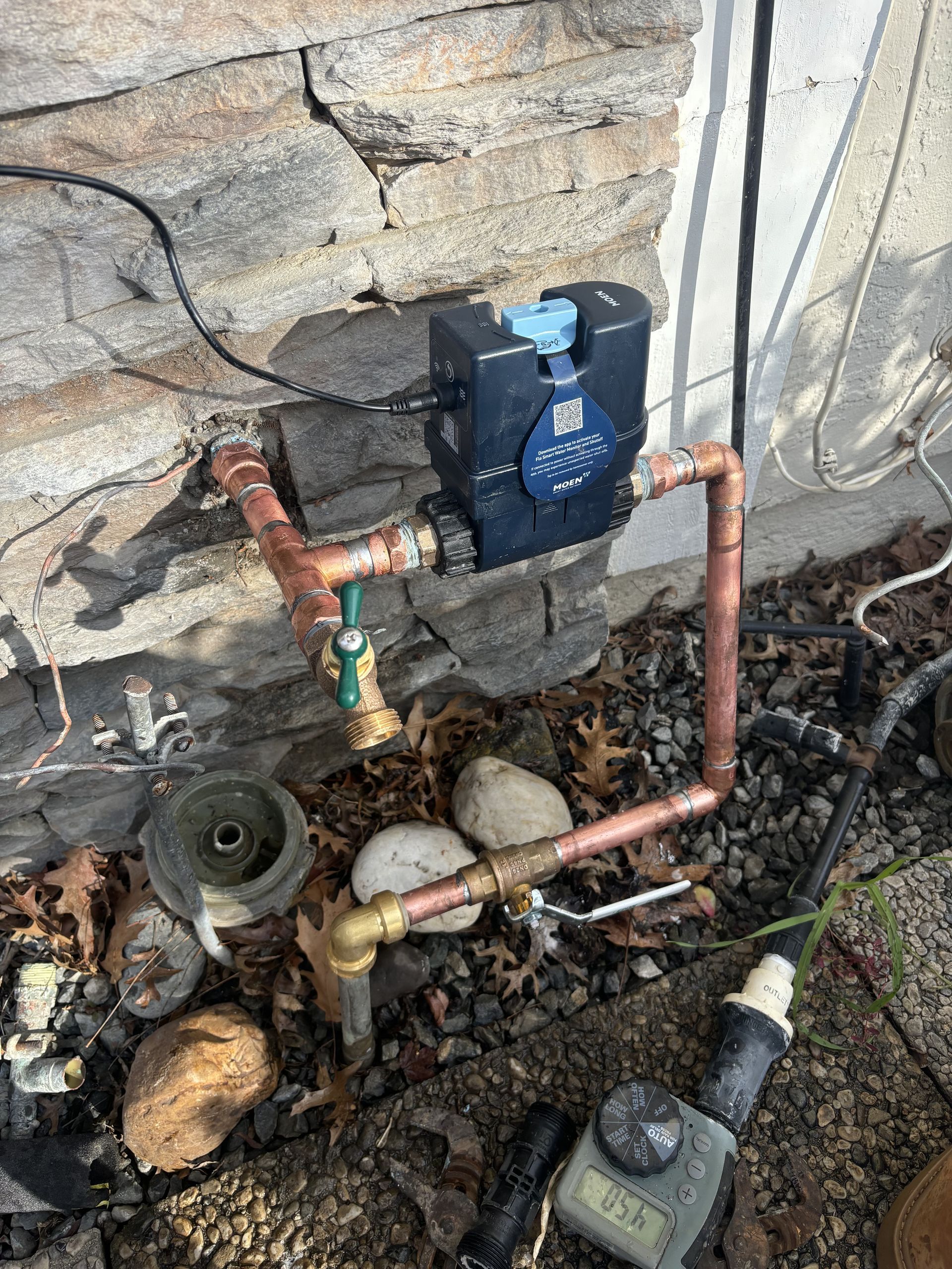 A wall-mounted electrical switch with surface conduit wiring is installed on a wooden panel for power control.
