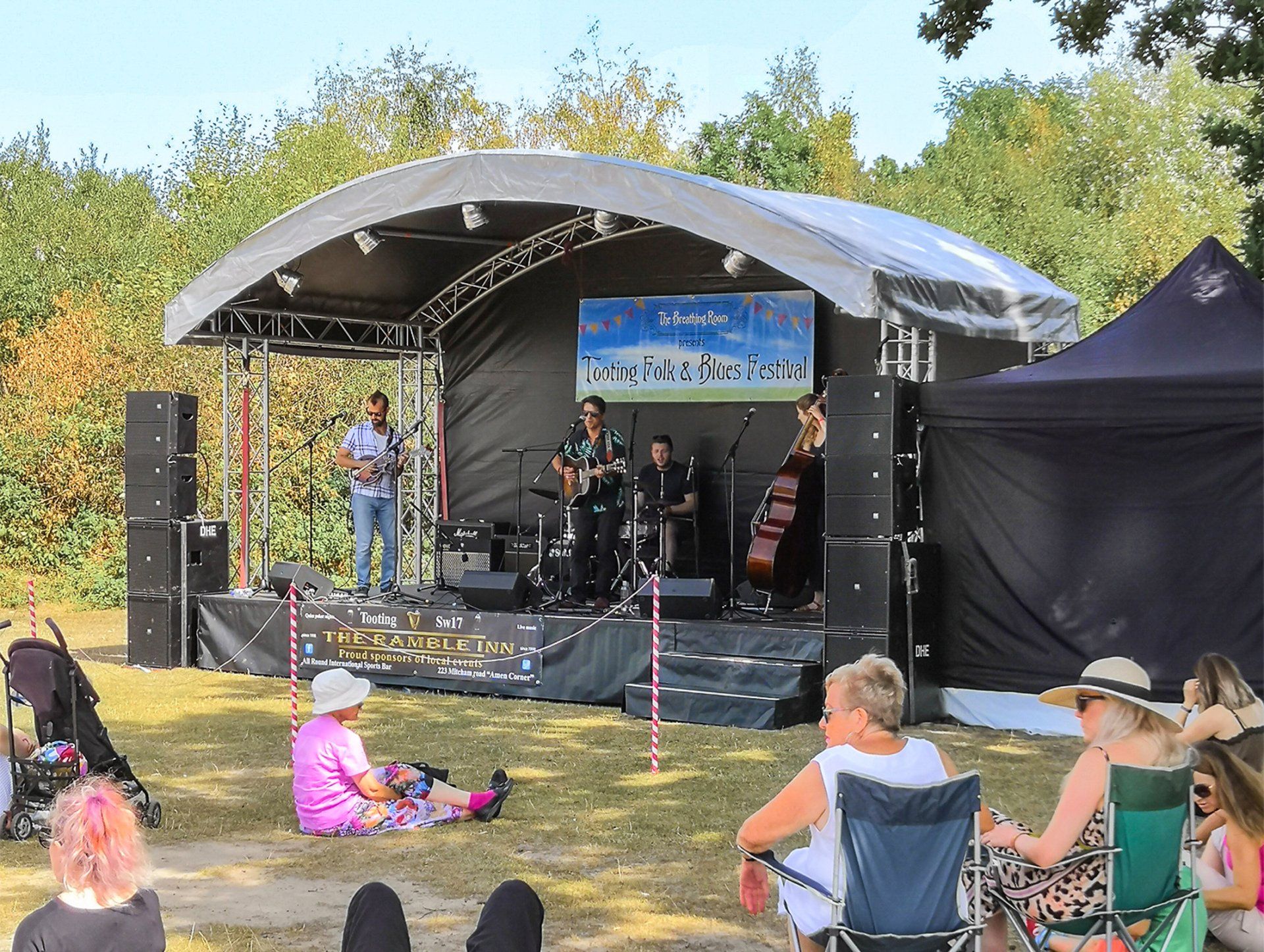 Arc stage set up with a band at an outdoor event