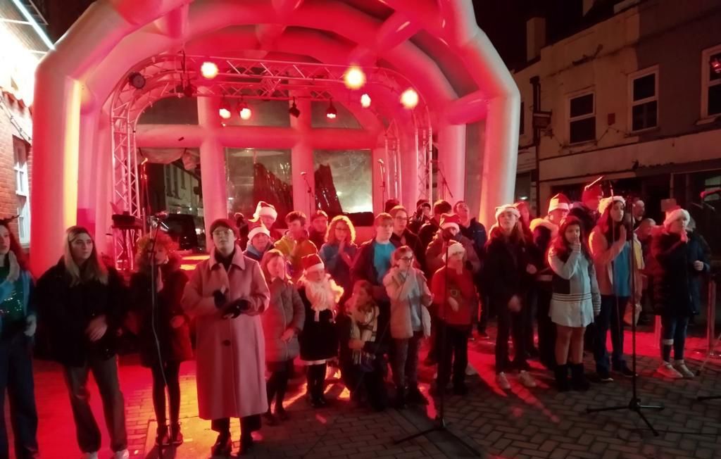 Inflatable stage bathed a red glow with a crowd stood in front