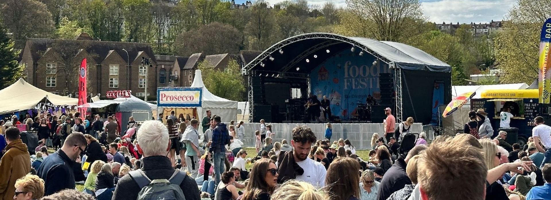 Arc Truss stage set up in a field with an audience in front to it for Foodies Festival