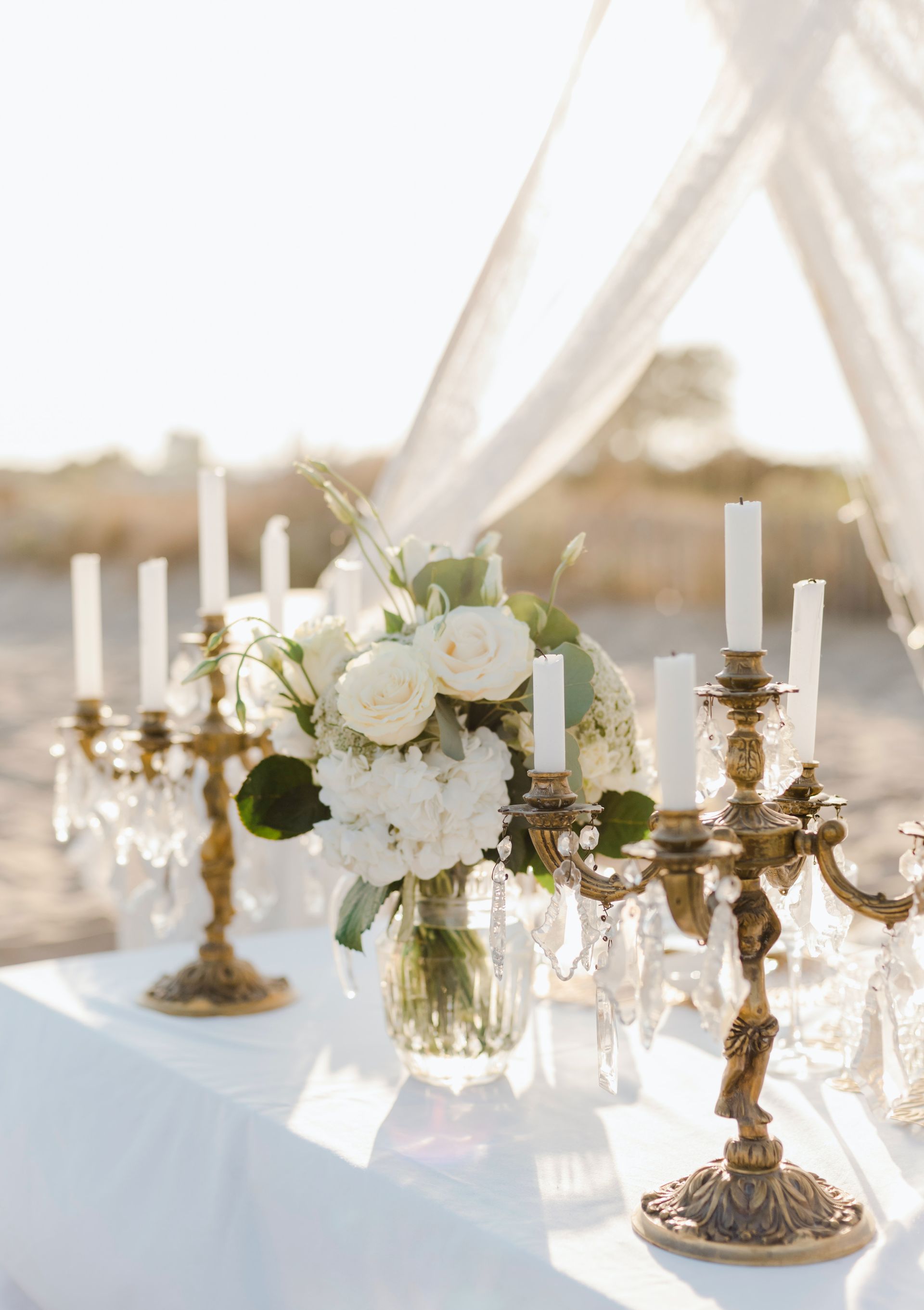 An outside alter with candles in candelabras