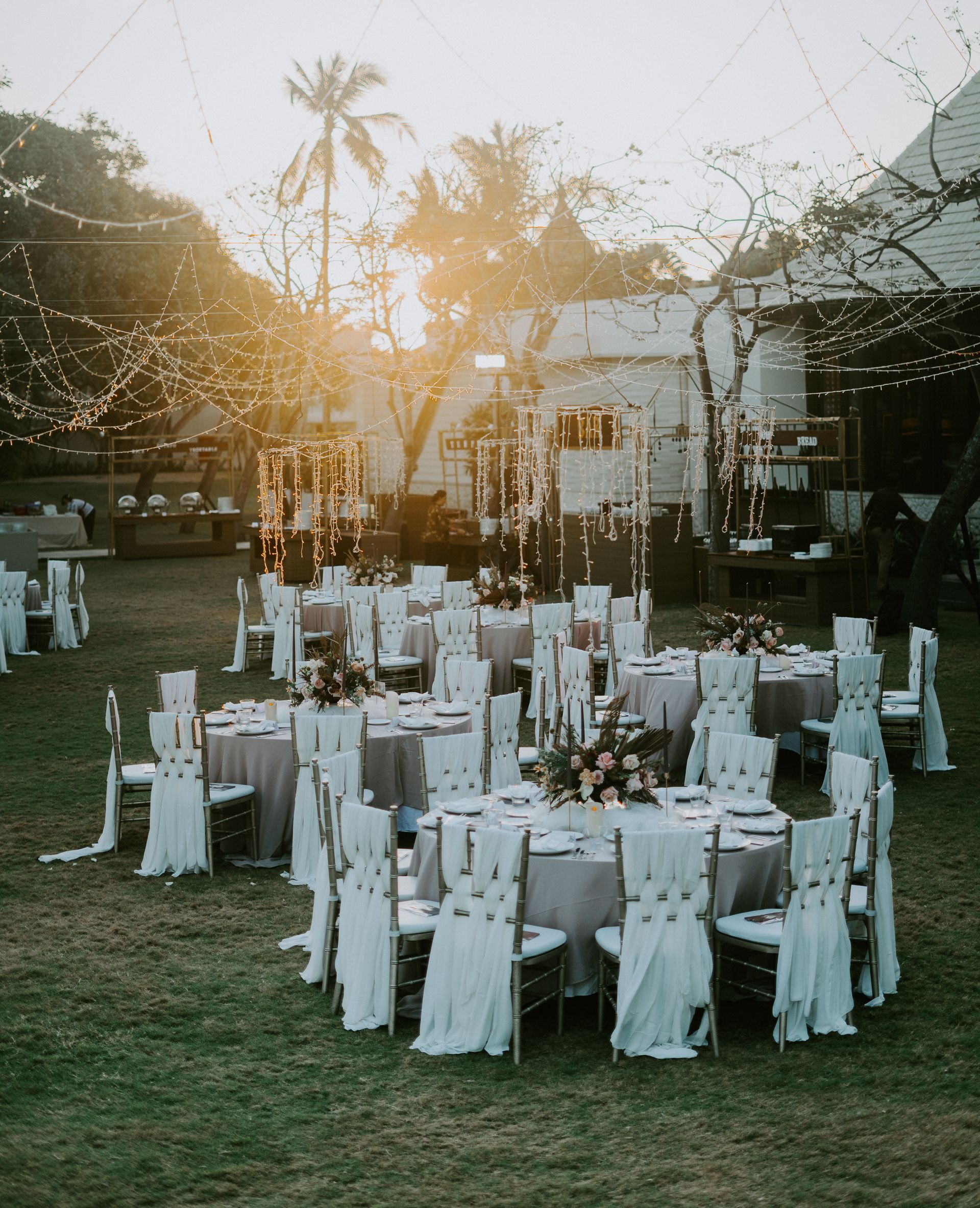 An outside wedding reception set up with fairy lights