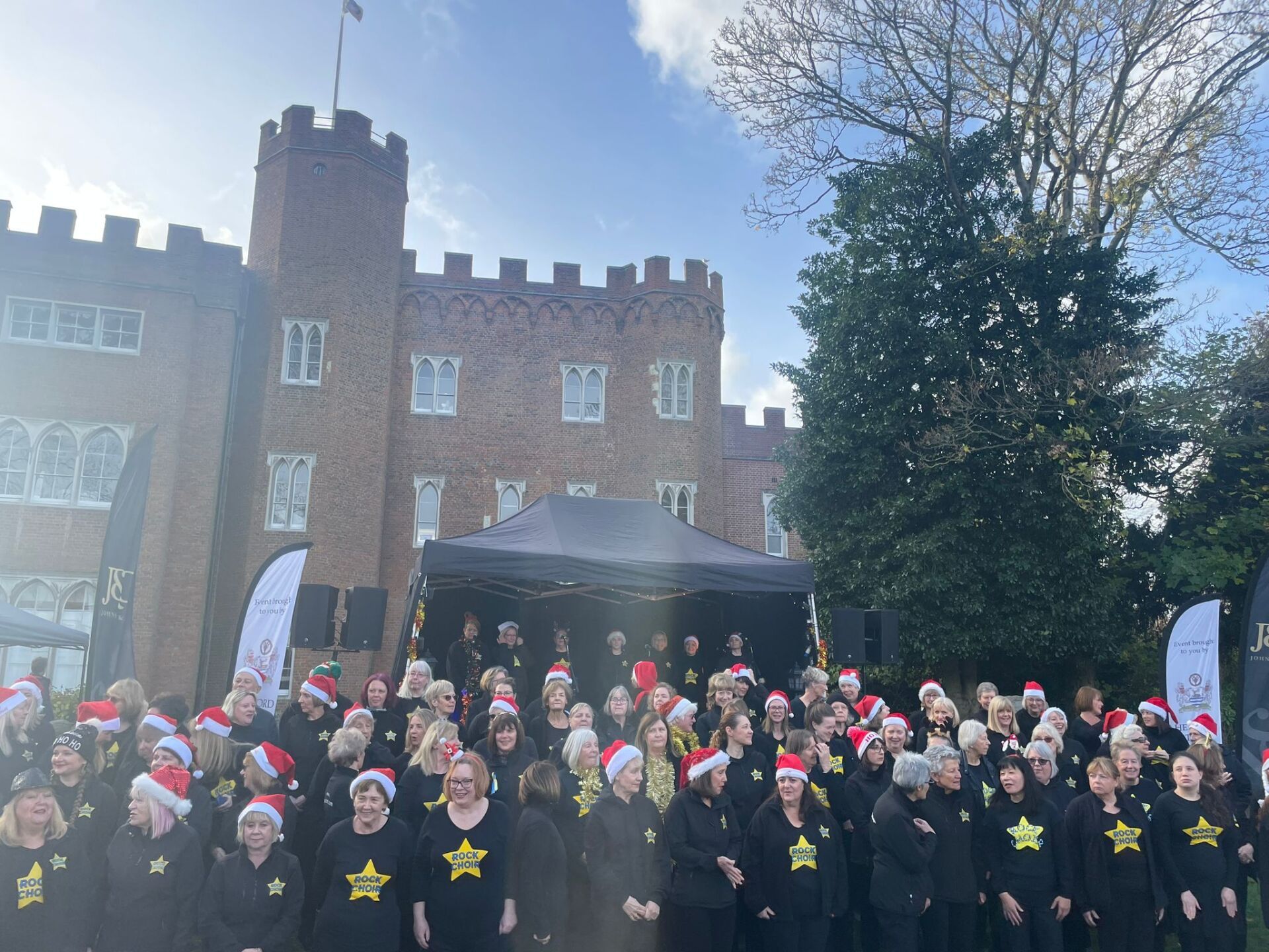 Rock Choir performing in front of hertford Castle