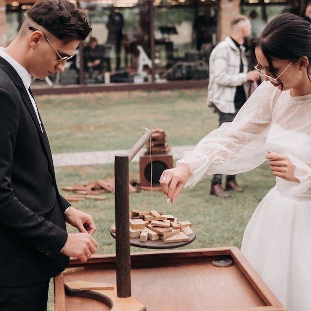 A bride and groom playing a wooden garden game