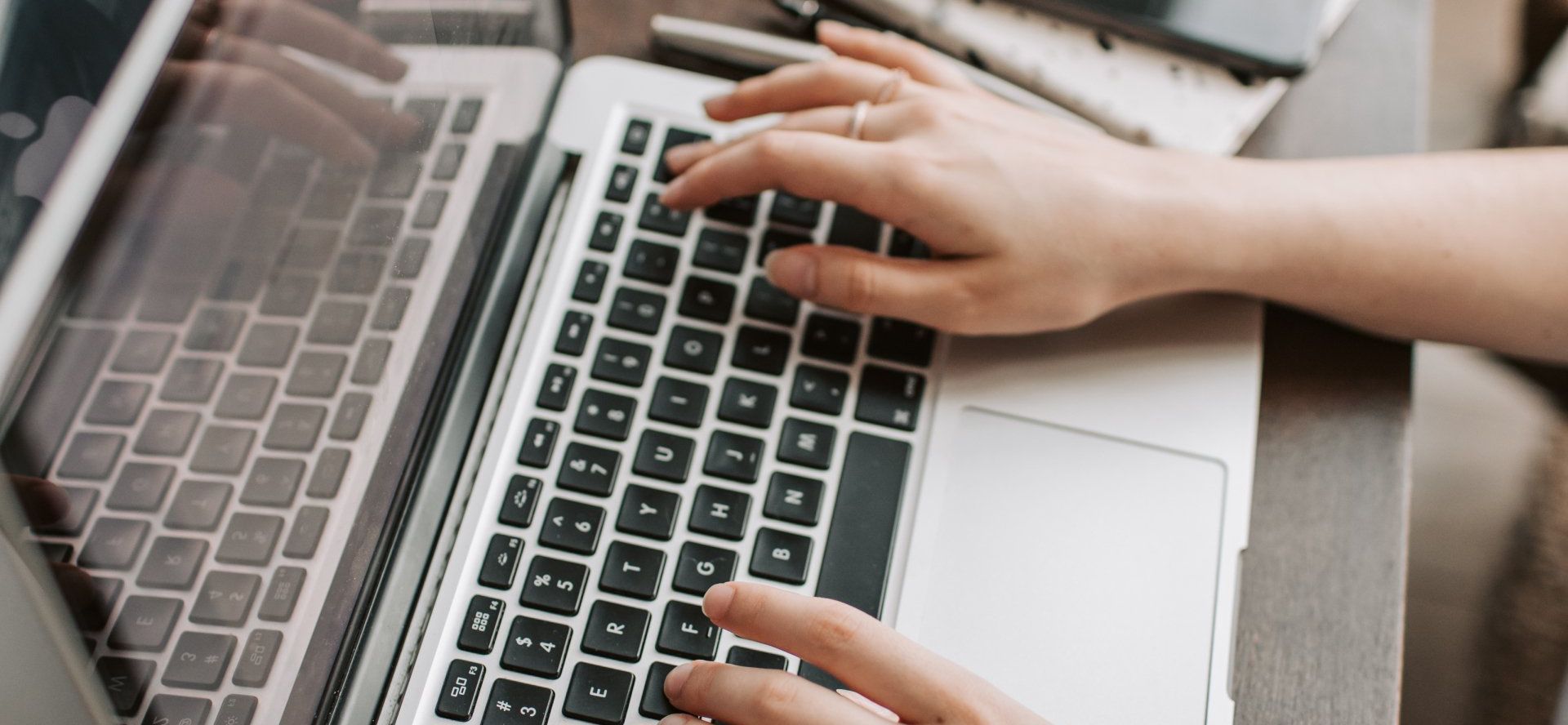 Close up of hands at a computer keyboard