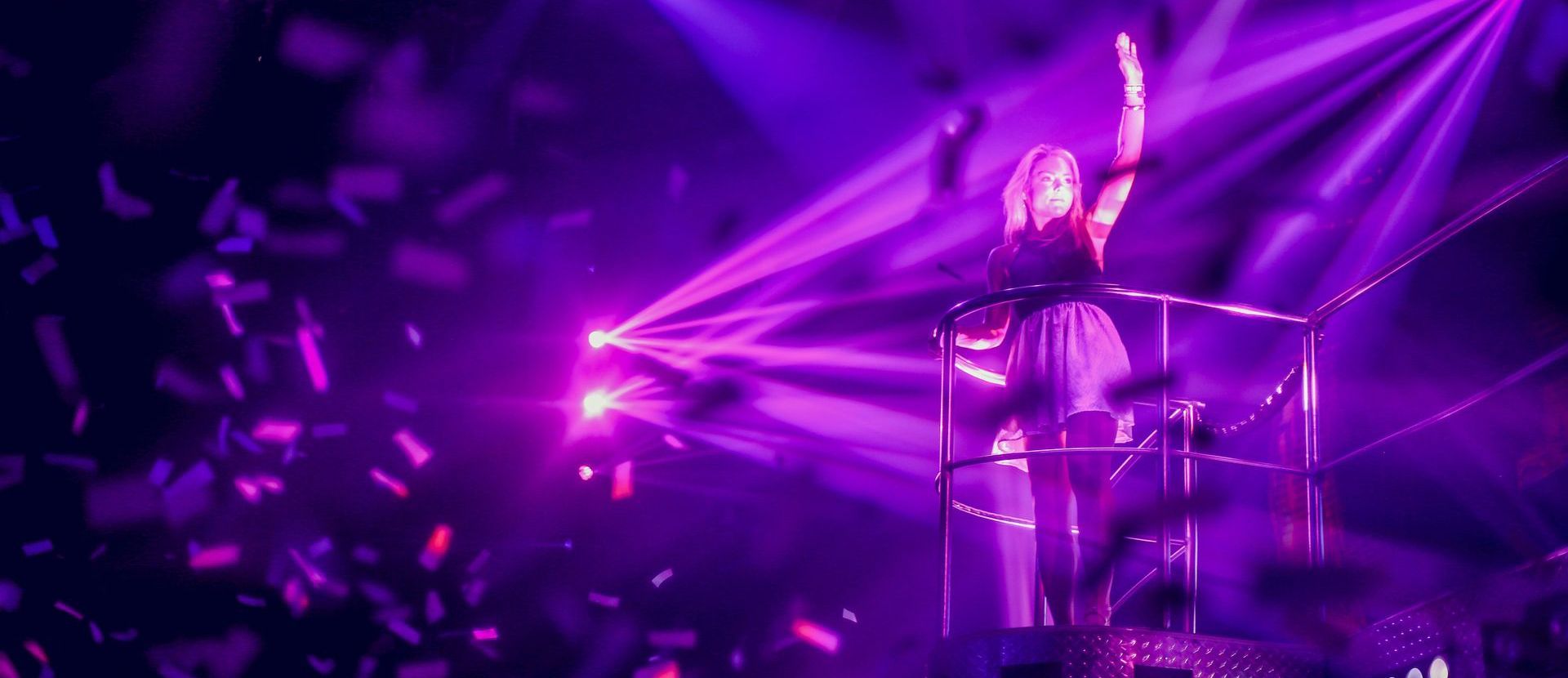 A performer on a stage with confetti raining down.