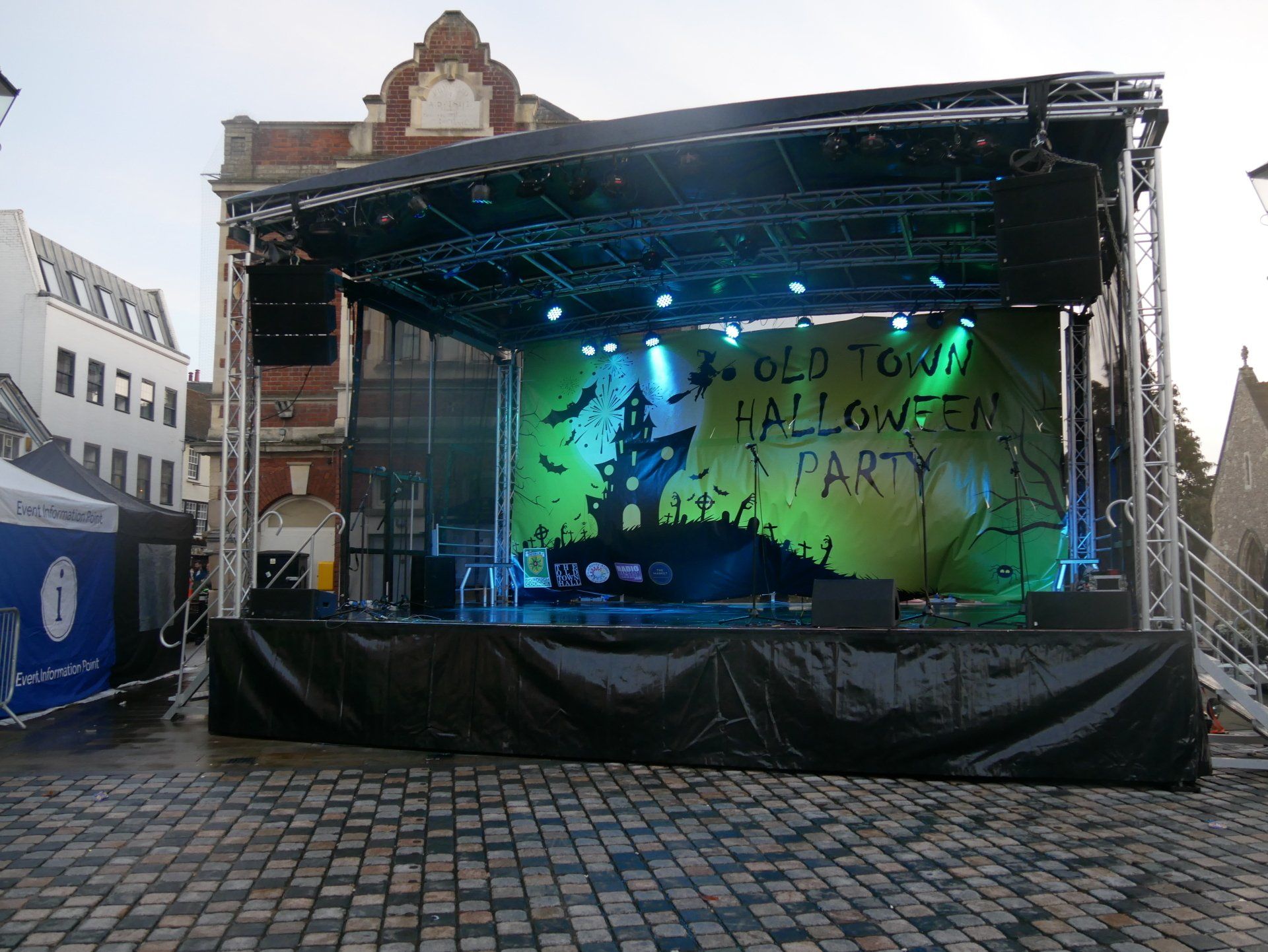 A stage set up with branded banners on the back  for the Halloween old town event in Hemel Hempstead