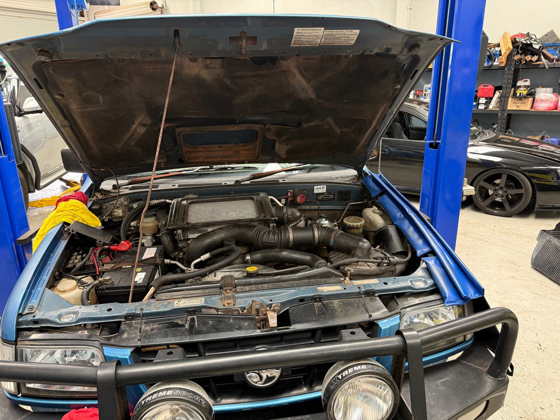 The Open Hood of a Blue Vehicle Showing the Engine Bay — Mad Monkeys Mechanical in Cairns City, QLD