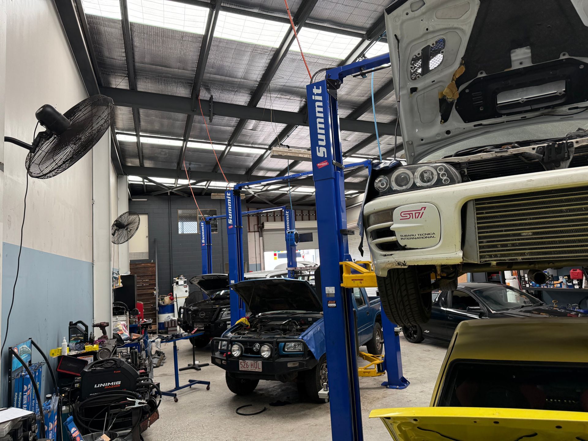 An Automotive Repair Shop Showing Several Cars Being Worked on — Mad Monkeys Mechanical in Cairns City, QLD