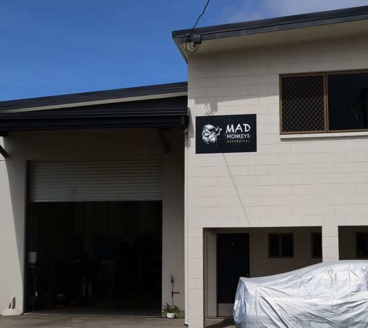 Industrial Building Exterior with Black Garage Door — Mad Monkeys Mechanical in Cairns City, QLD