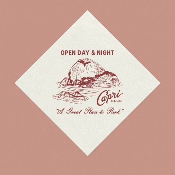 Diamond-shaped napkin with a brown Capri Club logo: an island, a car, and text