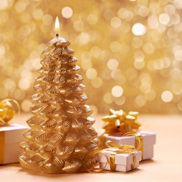 Golden Christmas tree candle with flame, and wrapped gifts against a blurred bokeh background.