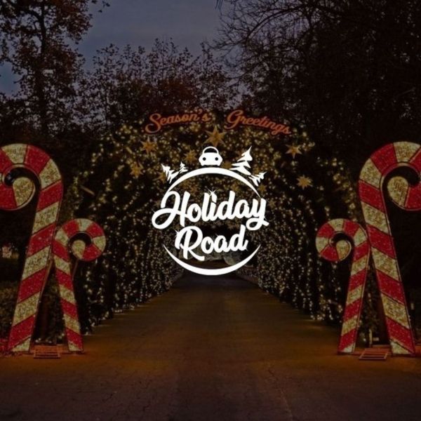 Holiday Road entrance with large candy canes and lights. Sign reads