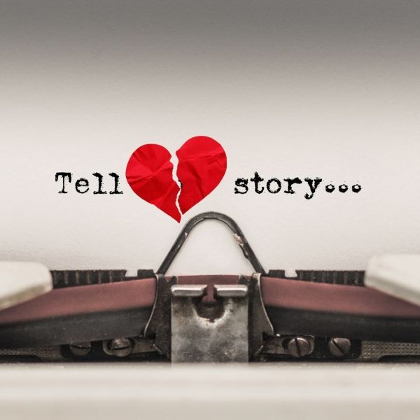 Typewriter with paper showing a broken heart and the words 