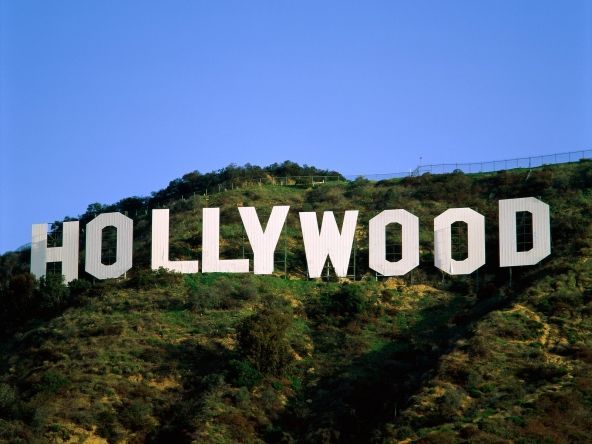 Hollywood sign on a hillside against a blue sky.