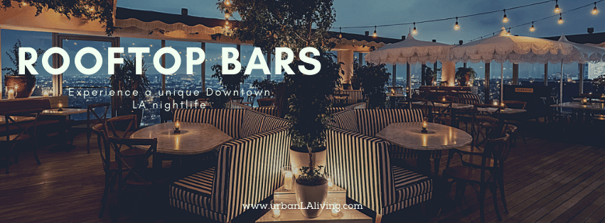 Rooftop bar with string lights and cityscape view at night.
