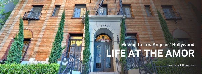 Exterior of a brick building with a central arched entrance, “Life at the Amor” text overlay.
