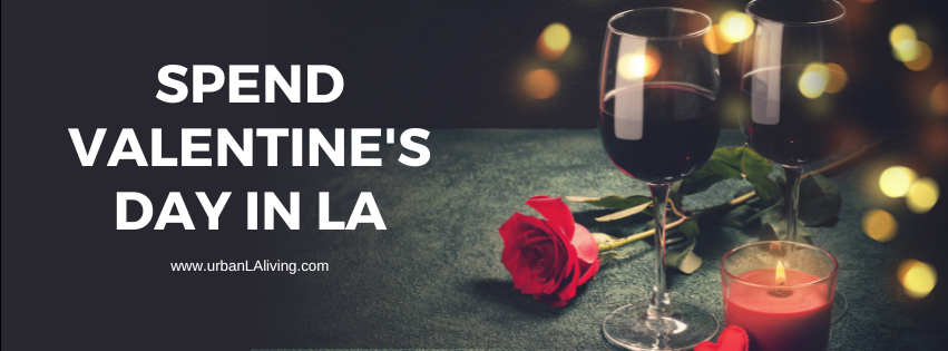 Valentine's Day in LA banner with wine glasses, a rose, and a candle on a dark surface.