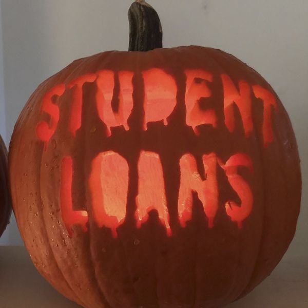 Carved pumpkin glows, displaying