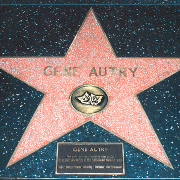 Gene Autry's star on the Hollywood Walk of Fame. A pink star with gold text, embedded in blue speckled pavement.