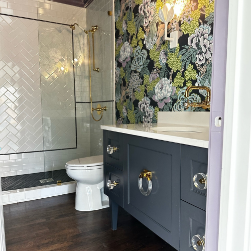 A bathroom with a toilet a sink and a shower