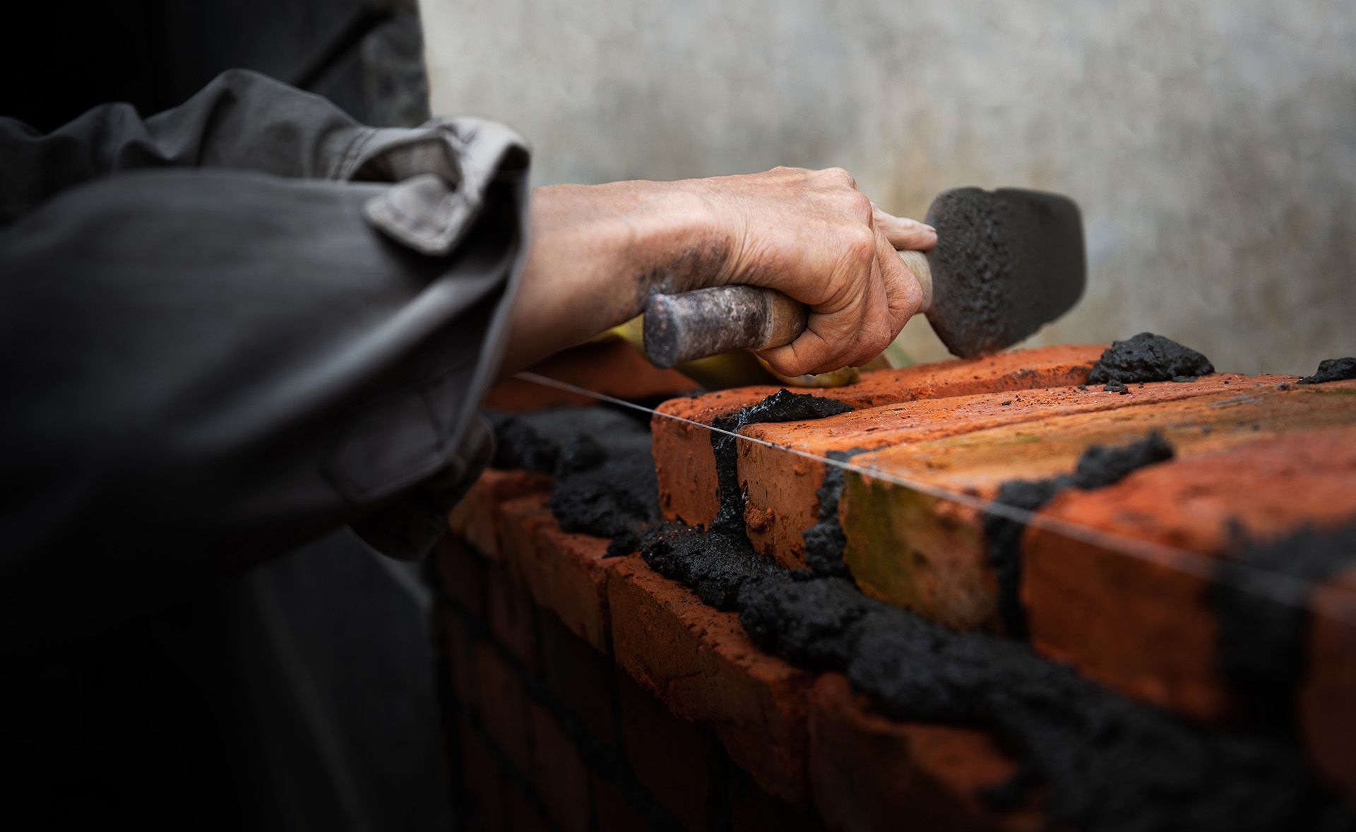Brick wall construction with fresh mortar application. Brick wall construction with fresh mortar application.