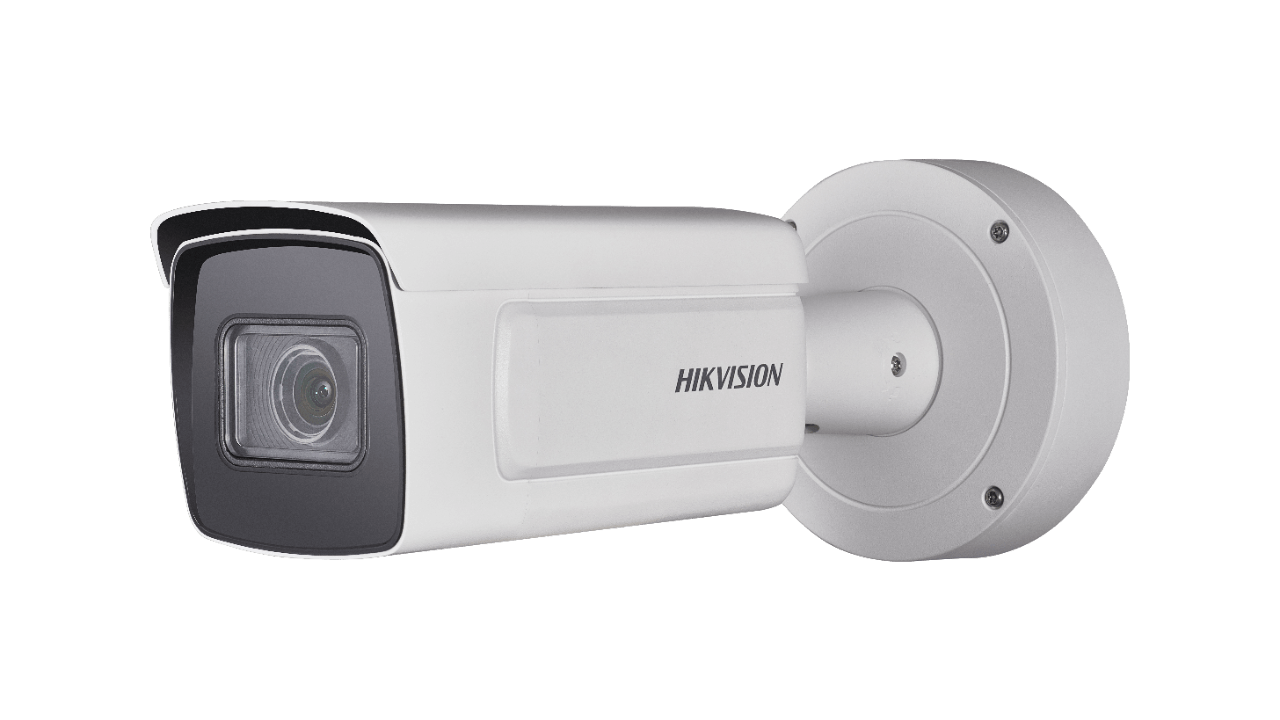 White Hikvision security camera mounted on a wall, capturing surveillance footage.