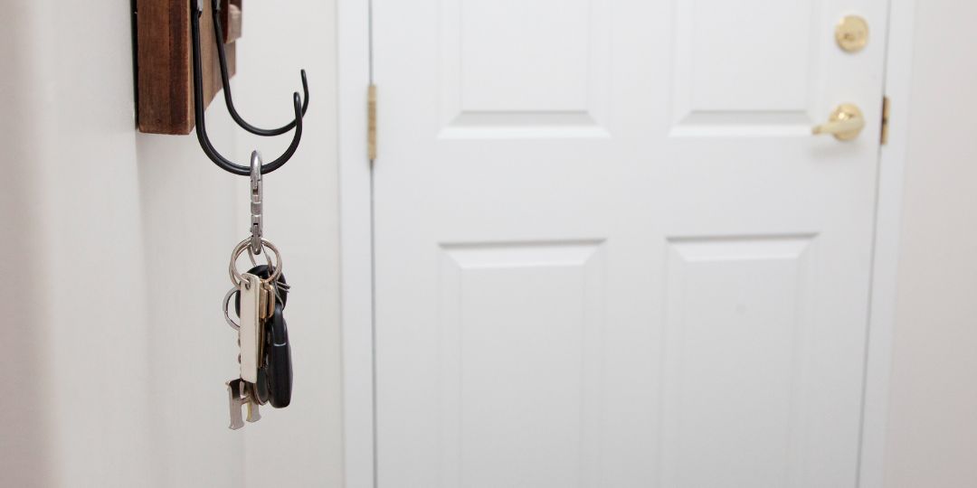 Organized Keys — Concord, NC — A A L Lock & Key Keys hanging on a hook next to a white door.