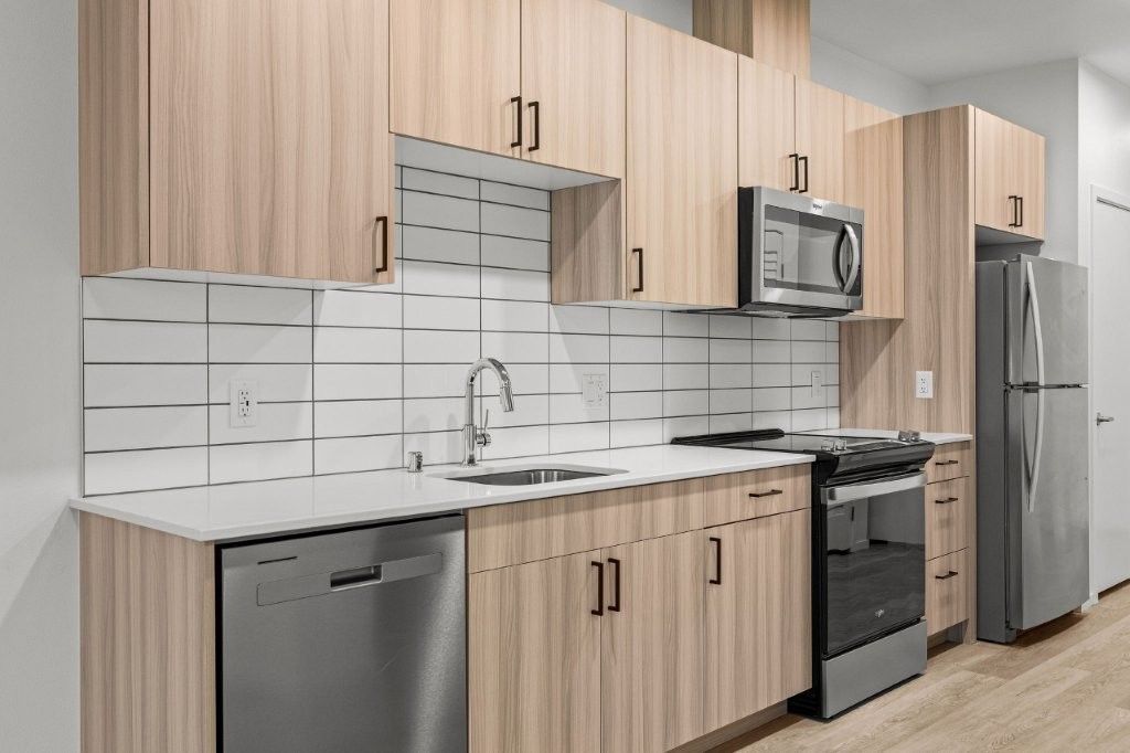 A kitchen with wooden cabinets and stainless steel appliances.