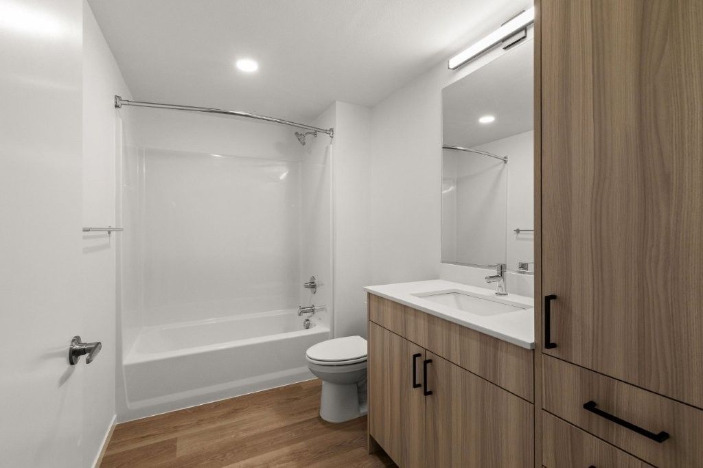 A bathroom with a toilet , sink , and bathtub.