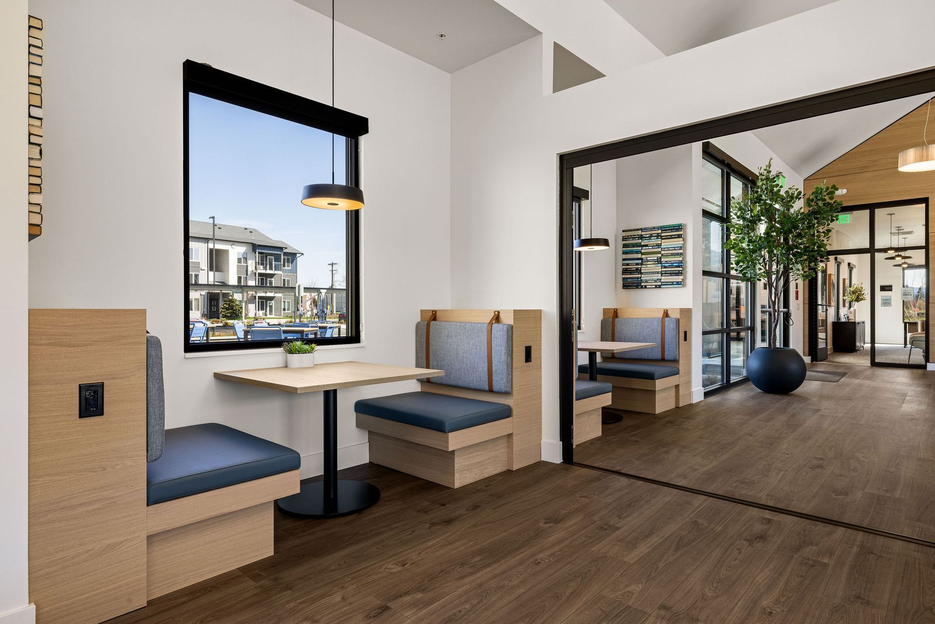 A room with tables and benches in it and a window.