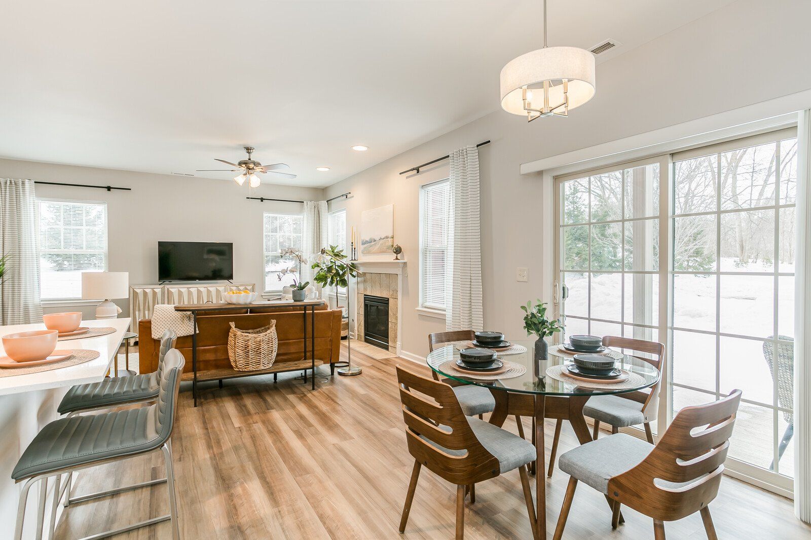 Living and dining room with great natural lighting and a fireplace