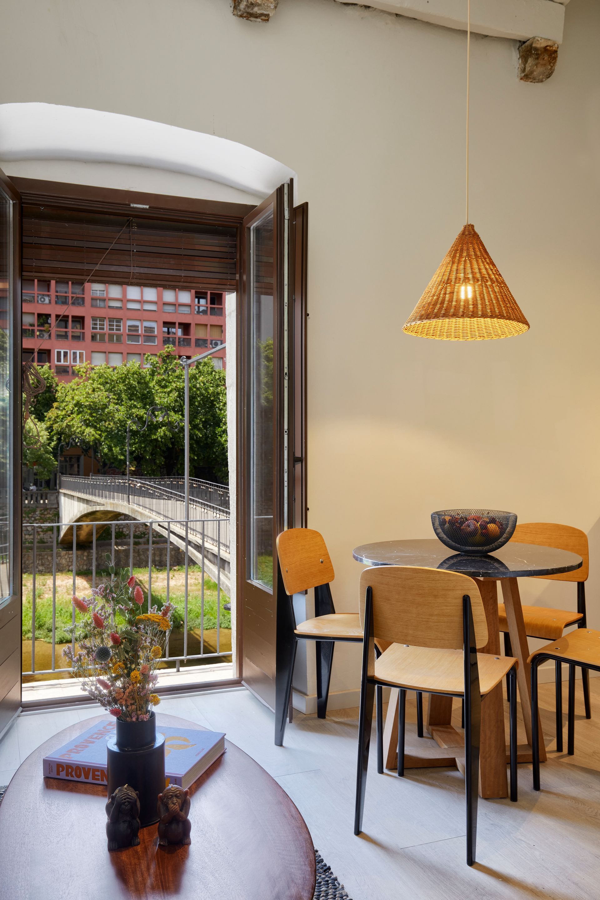A living room with a table and chairs and an open door