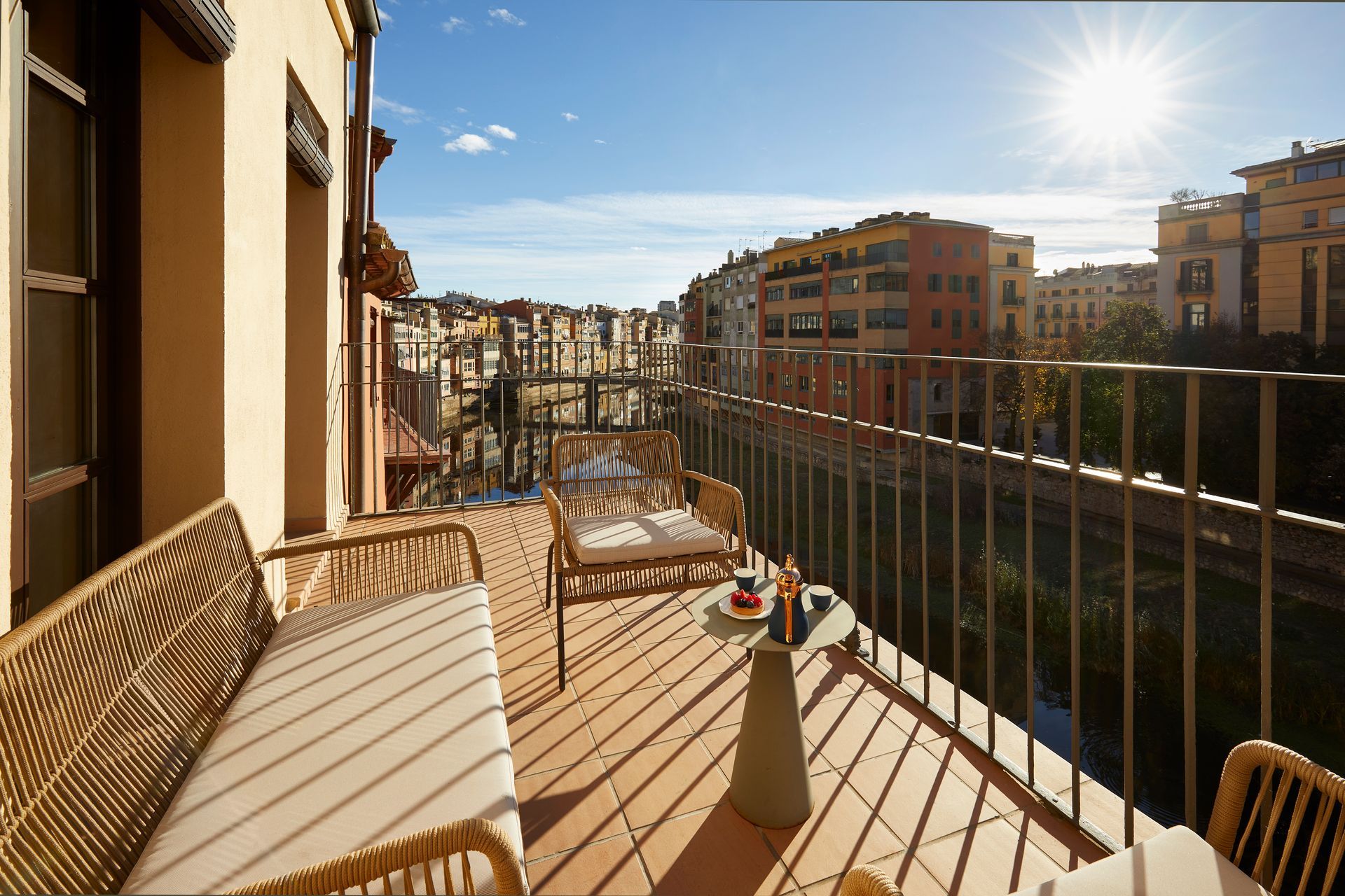 A balcony with a view of a city and a river