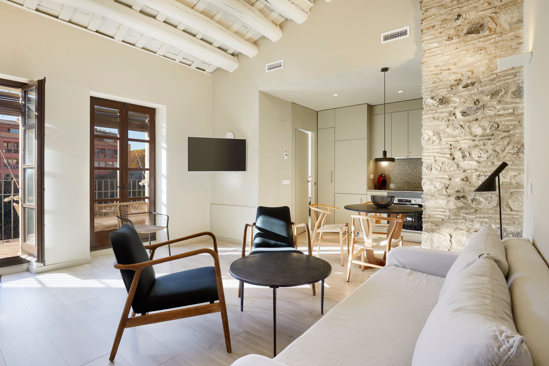 A living room with a couch , chairs , and a table.