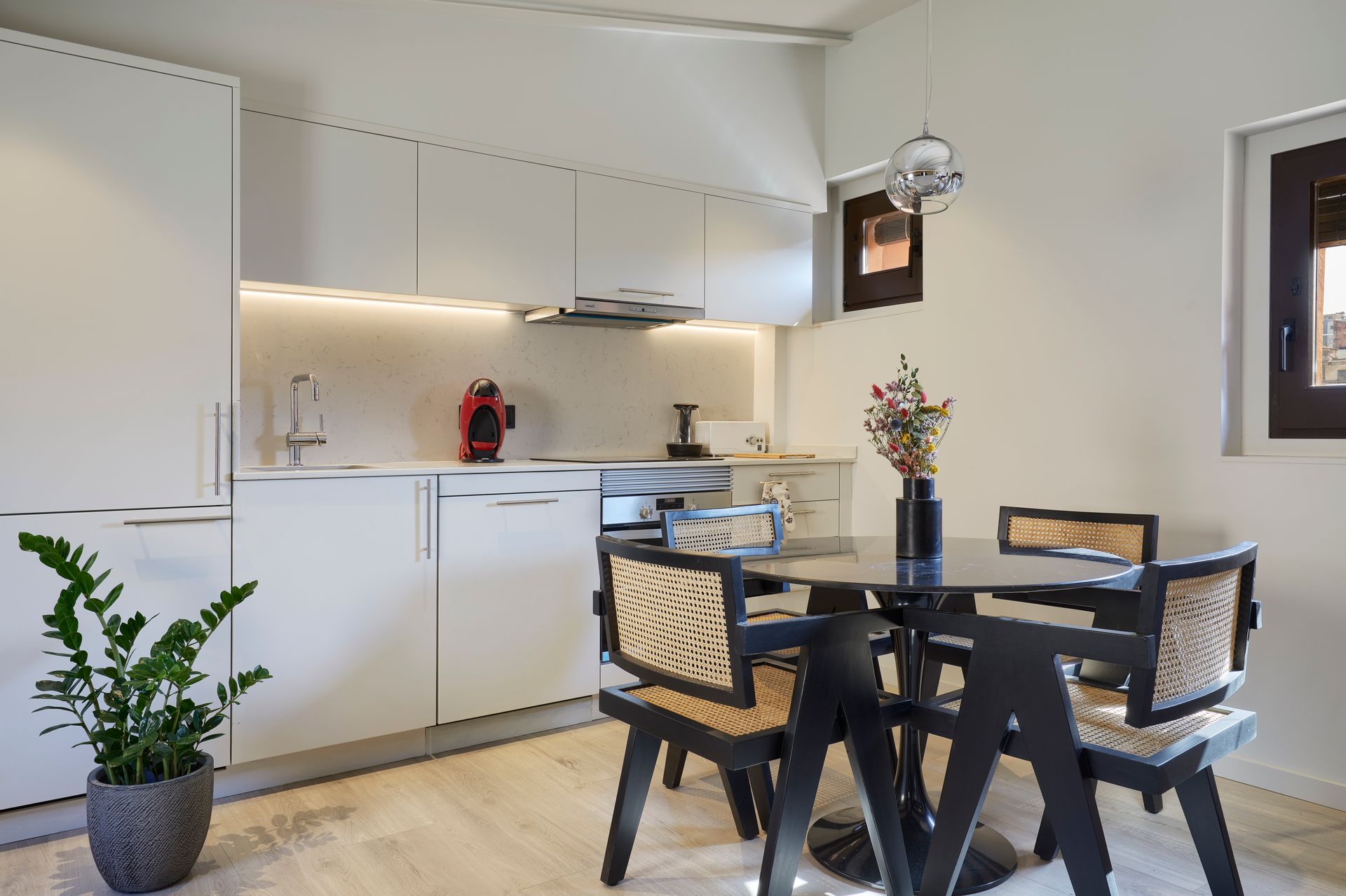 A kitchen with a table and chairs in it