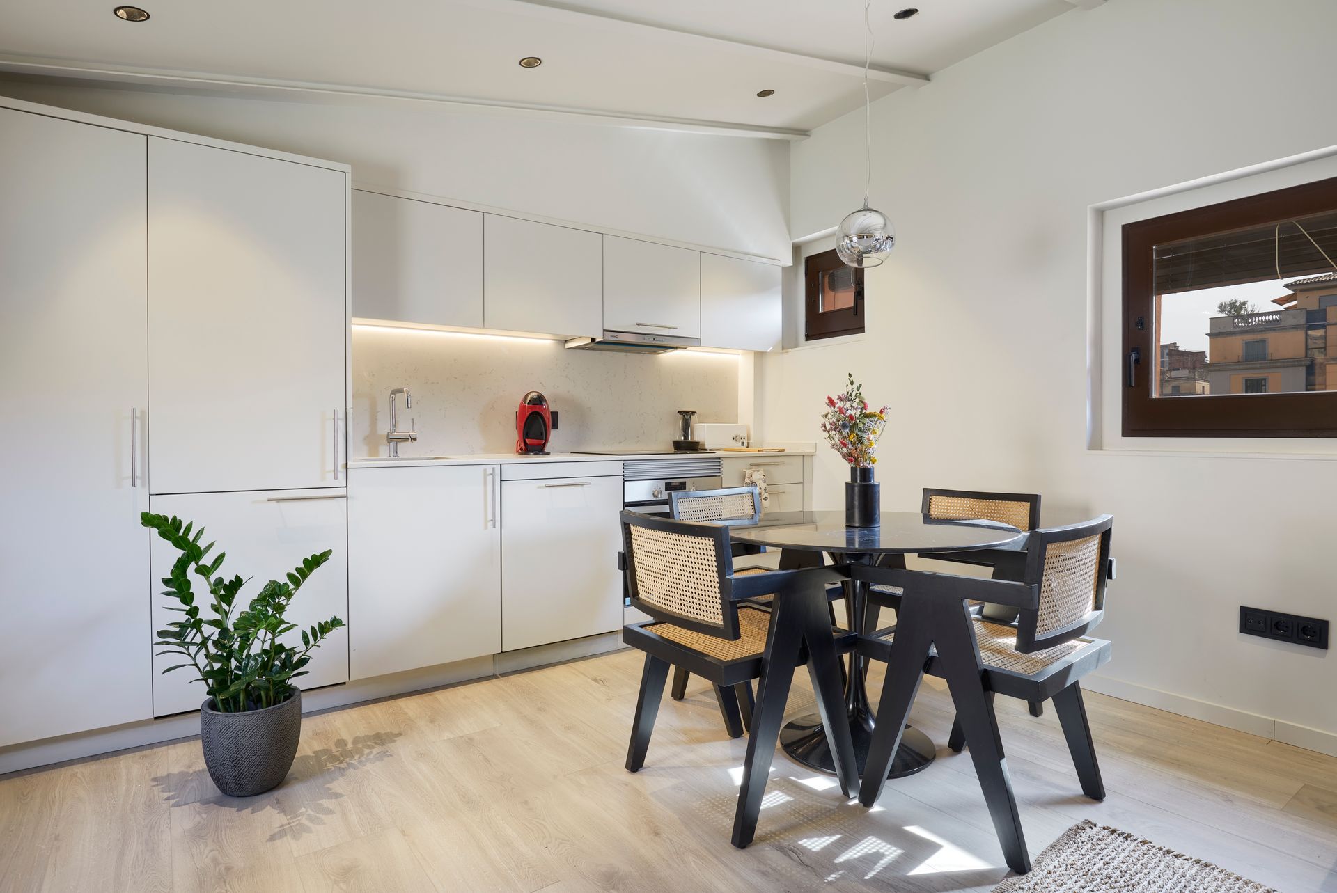 A kitchen with a table and chairs in it