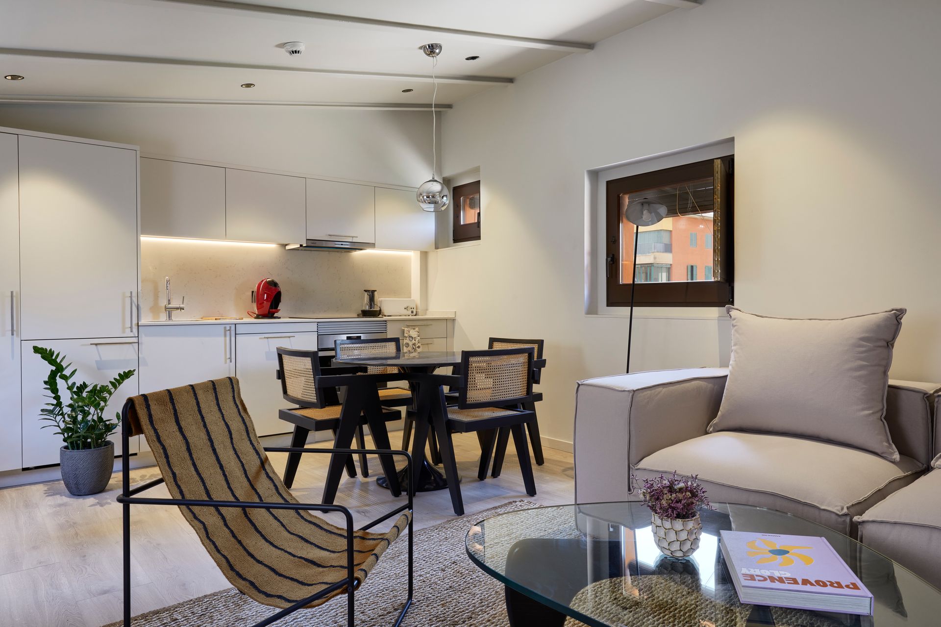 A living room with a table and chairs in it