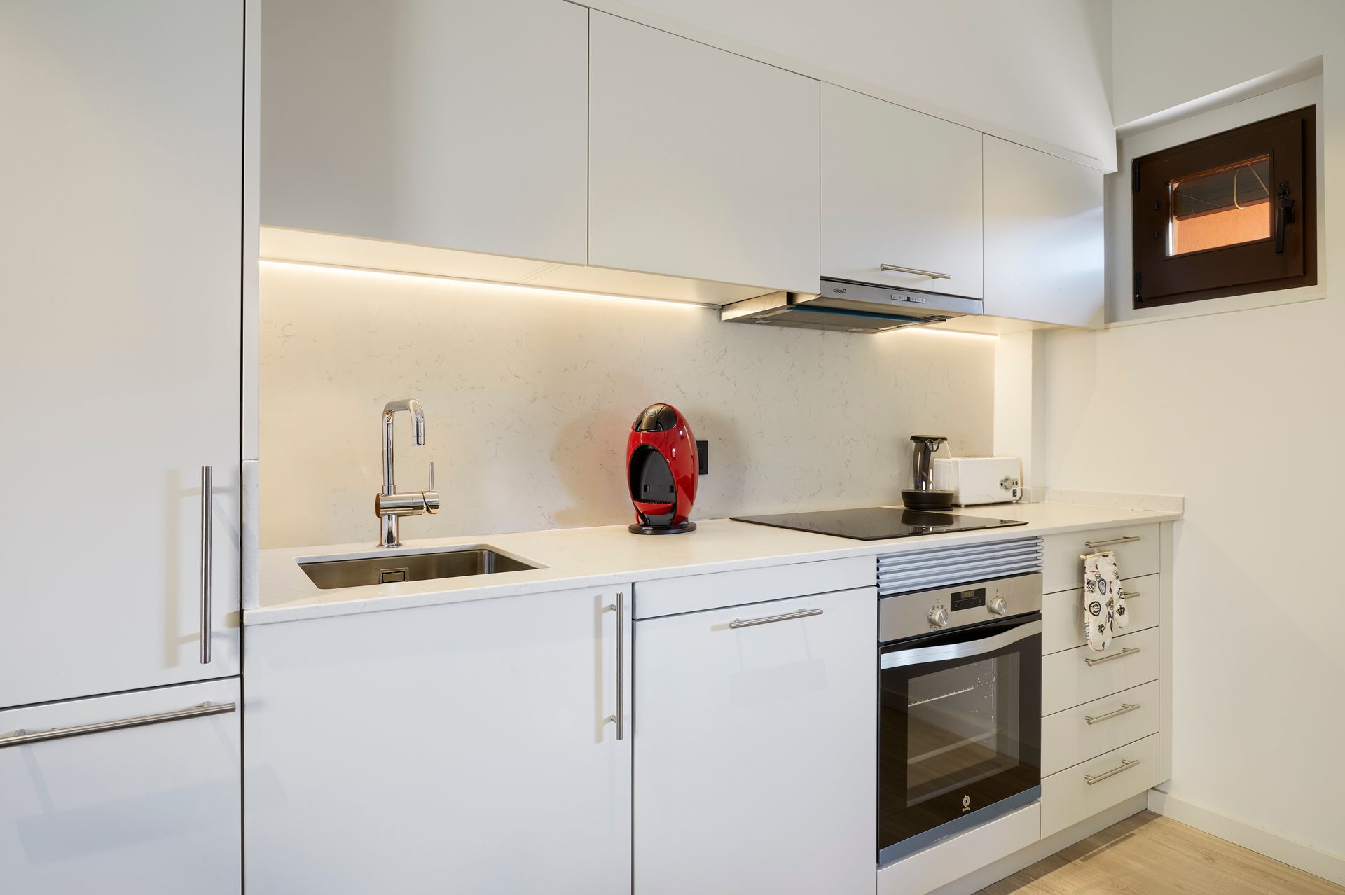 A kitchen with white cabinets and stainless steel appliances